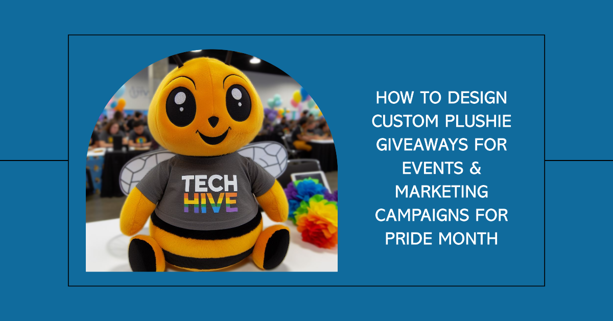 A custom plush toy mascot wearing a company t-shirt with Pride colors and the logo.