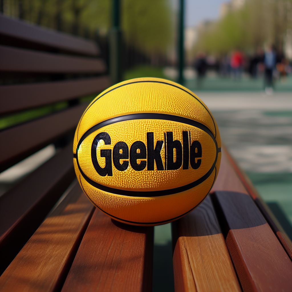 A yellow custom basketball with a logo on a park bench. 